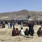 Hundreds of people gather near a U.S. Air Force C-17 transport plane at the perimeter of the international airport in Kabul, Afghanistan, Aug. 16, 2021. (AP Photo/Shekib Rahmani, File)