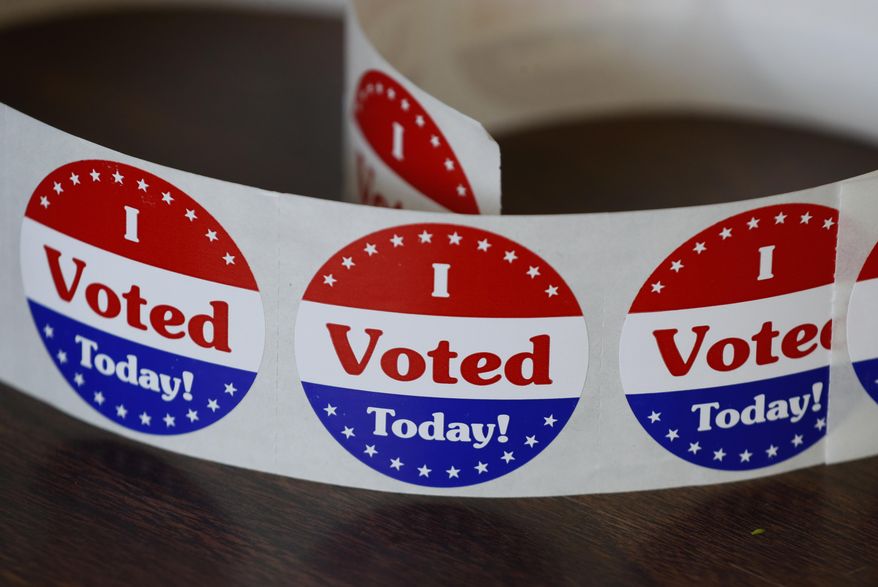 Stickers for voters in Iowa's Primary Election sit on a table at the Polk County Central Senior Center, Tuesday, June 2, 2020, in Des Moines, Iowa. (AP Photo/Charlie Neibergall)