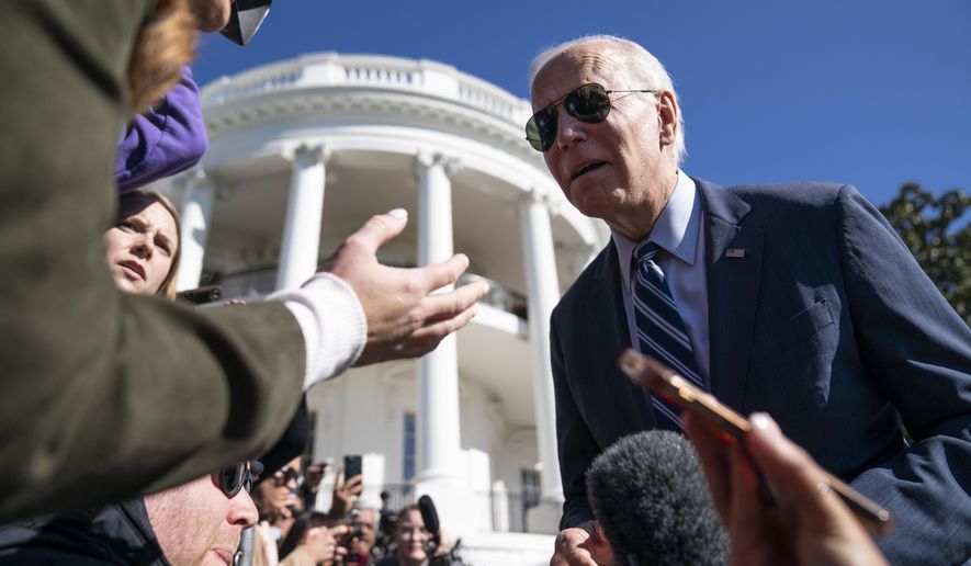 President Joe Biden talks with reporters before boarding Marine One on the South Lawn of the White House, Thursday, Oct. 20, 2022, in Washington. (AP Photo/Evan Vucci)