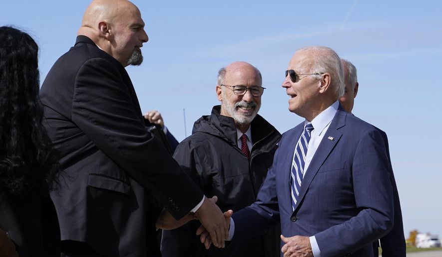 President Joe Biden speaks with Pennsylvania Lt. Gov. John Fetterman, a Democratic candidate for U.S. Senate, after stepping off Air Force One, Thursday, Oct. 20, 2022, at the 171st Air Refueling Wing at Pittsburgh International Airport in Coraopolis, Pa. Biden is visiting Pittsburgh to promote his infrastructure agenda. (AP Photo/Patrick Semansky)