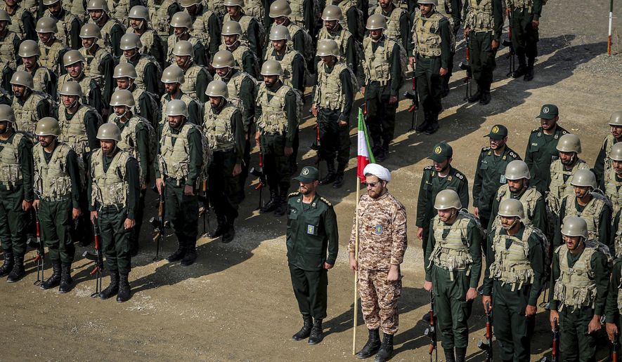 In this photo provided by the Revolutionary Guard&#x27;s Ground Force Oct. 17, 2022, troops stand while attending a manoeuver in northwestern Iran. As protests rage at home, Iran&#x27;s theocratic government is increasingly flexing its military muscle abroad. That includes supplying drones to Russia that now kill Ukrainian civilians, running drills in a border region with Azerbaijan and bombing Kurdish positions in Iraq. (Iranian Revolutionary Guard&#x27;s Ground Force via AP, File)