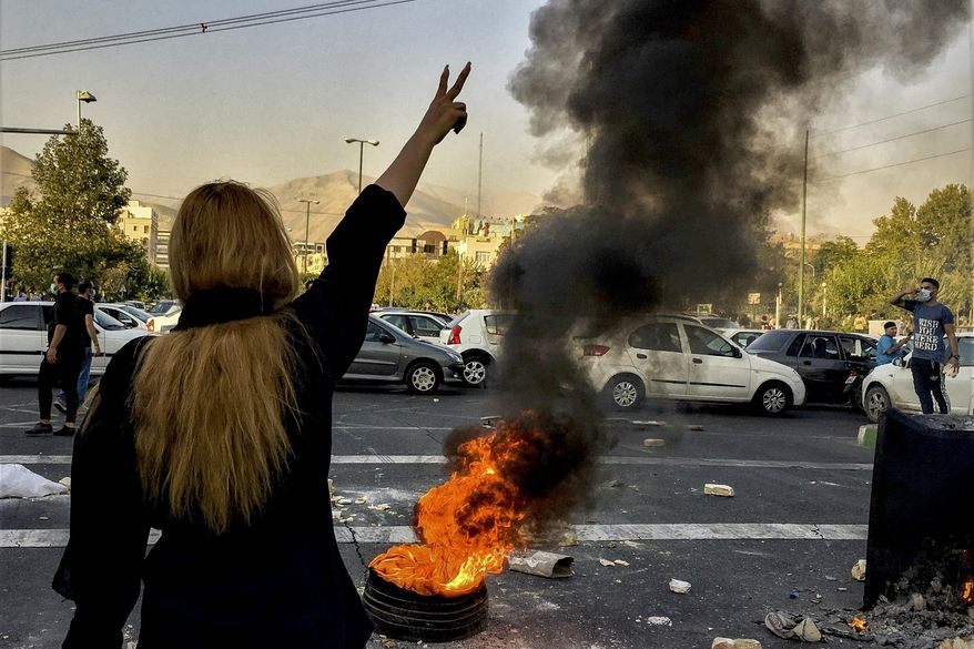 In this photo taken by an individual not employed by the Associated Press and obtained by the AP outside Iran, Iranians protest the death of 22-year-old Mahsa Amini after she was detained by the morality police, in Tehran, Oct. 1, 2022. (AP Photo/Middle East Images, File)