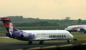 A Hawaiian Airlines plane taxis at Kahalui, Hawaii on the island of Maui on March 24, 2005. Hawaiian Airlines will operate 10 cargo planes for Amazon.com starting next fall under a deal that could eventually involve more planes and give Amazon a 15% stake in the airline, the airline’s parent company, Hawaiian Holdings Inc., said Friday, Oct. 21, 2022. (AP Photo/Lucy Pemoni, FIle)