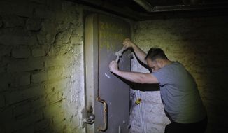 Jacek, 37, a local resident, closes a door to a shelter in the basement of a residential building in Warsaw, Poland, Wednesday, Oct. 19, 2022. Fighting around Ukraine&#39;s nuclear power plants and Russia&#39;s threats to use nuclear weapons have reawakened nuclear fears in Europe. This is especially felt in countries near Ukraine, like Poland, where the government this month ordered an inventory of the country&#39;s shelters as a precaution. (AP Photo/Michal Dyjuk)