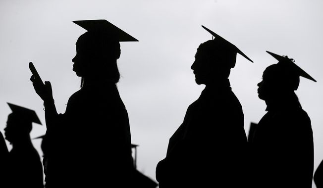 New graduates line up before the start of a community college commencement in East Rutherford, N.J., May 17, 2018. (AP Photo/Seth Wenig, File)