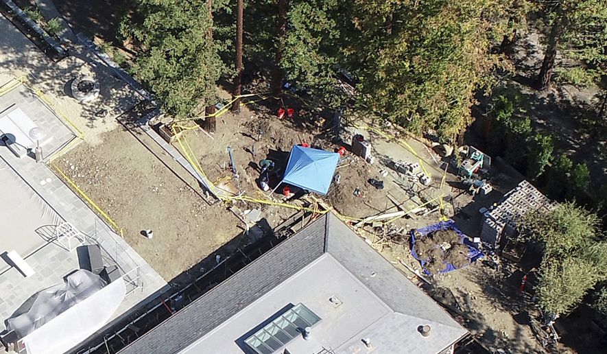 A mansion is under investigation by police after a car was found buried on the property the day before, in Atherton, Calif., Friday, Oct. 21, 2022. Three decades after a car was reported stolen in Northern California, police are digging the missing convertible out of the yard of a $15 million mansion built by a man with a history of arrests for murder, attempted murder and insurance fraud. (Nhat V. Meyer/Bay Area News Group via AP)