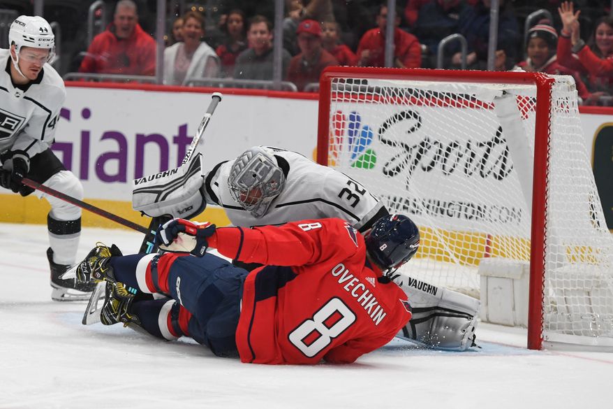 Washington Capitals left wing Alex Ovechkin (8) sliding in front of Los Angeles Kings goalie Jonathan Quick (32) during the 1st period in a game against the Los Angeles Kings at Capital One Arena in Washington D.C., October 22, 2022. (Photo by Billy Sabatini)