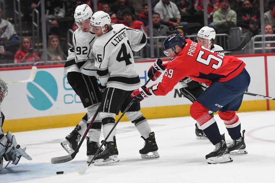 Washington Capitals center Aliaksel Protas (59) reaching for the puck in front of the net during the 2nd period in a game against the Los Angeles Kings at Capital One Arena in Washington D.C., October 22, 2022. (Photo by Billy Sabatini)