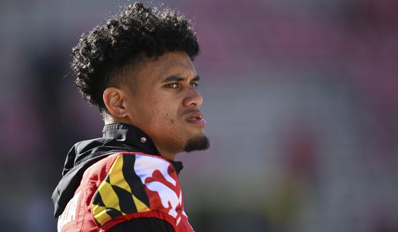 Maryland quarterback Taulia Tagovailoa looks on during warm ups before an NCAA college football game against Northwestern, Saturday, Oct. 22, 2022, in College Park, Md. Tagovailoa was injured last game and was not in the starting lineup Saturday. (AP Photo/Gail Burton)