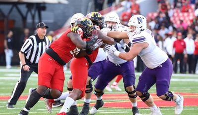 Maryland Terrapins DL TOMMY AKINGBESOTE (99) holding and pushing to hold back the offense at the Maryland Terrapins vs Northwestern at SECU Stadium in College Park, MD on October 22nd 2022 (Photo: All-Pro Reels/Alyssa Howell)