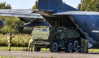 Soldiers load a High-Mobility Artillery Rocket System (HIMARS) from a U.S. Special Operations MC-130J aircraft during military exercises at Spilve Airport in Riga, Latvia, Monday, Sept. 26, 2022. (AP Photo/Roman Koksarov, File)