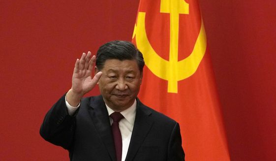 Chinese President Xi Jinping waves at an event to introduce new members of the Politburo Standing Committee at the Great Hall of the People in Beijing on Oct. 23, 2022. The world faces the prospect of more tension with China over trade, security and human rights after Xi Jinping awarded himself a third five-year term on Oct. 23, 2022, as leader of the ruling Communist Party. (AP Photo/Andy Wong) **FILE**