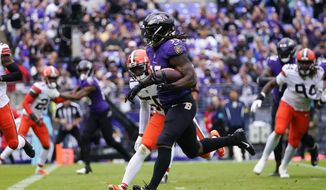 Baltimore Ravens running back Gus Edwards (35) runs past Cleveland Browns linebacker Jacob Phillips (50) to score a touchdown in the first half of an NFL football game Sunday, Oct. 23, 2022, in Baltimore. (AP Photo/Julio Cortez)