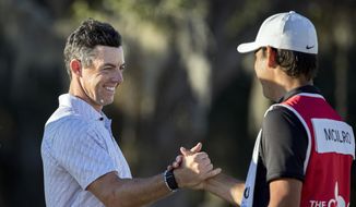 Rory McIlroy, left, of Northern Ireland, left, celebrates with his caddie after the final round of the CJ Cup golf tournament Sunday, Oct. 23, 2022, in Ridgeland, S.C. (AP Photo/Stephen B. Morton) **FILE**