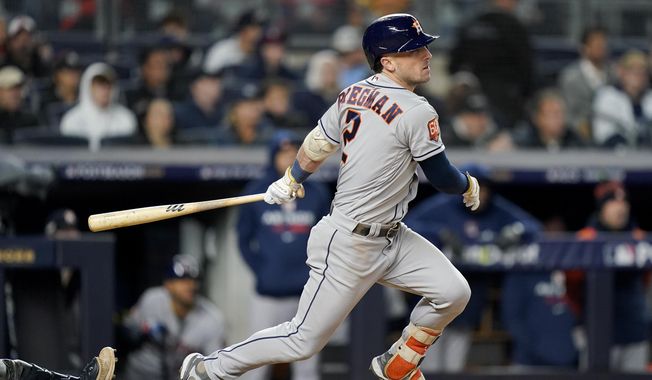 Houston Astros Alex Bregman (2) follows through on a base hit to drive in a run against the New York Yankees during the seventh inning of Game 4 of an American League Championship baseball series, Sunday, Oct. 23, 2022, in New York. (AP Photo/John Minchillo)