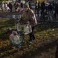Catherine, 75, pushes her walker loaded with plastic bottles after refilling them in a tank, in the center of Mykolaiv, Monday, Oct. 24, 2022. Since mid-April, citizens of Mykolaiv, with a pre-war population of half a million people, have lived without a centralized drinking water supply. Russian Forces cut off the pipeline through which the city received drinking water for the last 40 years. (AP Photo/Emilio Morenatti)