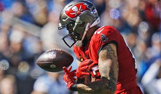 Tampa Bay Buccaneers wide receiver Mike Evans (13) drops a pass during the first half of an NFL football game against he Carolina Panthers Sunday, Oct. 23, 2022, in Charlotte, N.C. (AP Photo/Rusty Jones)