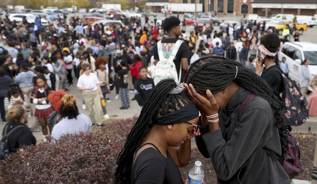 Students stand in a parking lot near the Central Visual &amp;amp; Performing Arts High School after a reported shooting at the school in St. Louis on Monday, Oct. 24, 2022. (David Carson/St. Louis Post-Dispatch via AP)