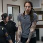 WNBA star and two-time Olympic gold medalist Brittney Griner is escorted from a courtroom after a hearing in Khimki just outside Moscow, Russia, on Aug. 4, 2022. A Russian court on Tuesday started hearing American basketball star Brittney Griner&#39;s appeal against her nine-year prison sentence for drug possession. (AP Photo/Alexander Zemlianichenko, File)