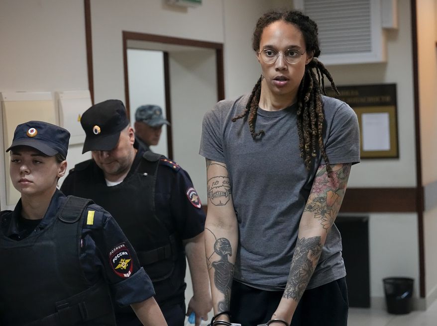 WNBA star and two-time Olympic gold medalist Brittney Griner is escorted from a courtroom after a hearing in Khimki just outside Moscow, Russia, on Aug. 4, 2022. A Russian court on Tuesday started hearing American basketball star Brittney Griner&#x27;s appeal against her nine-year prison sentence for drug possession. (AP Photo/Alexander Zemlianichenko, File)