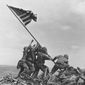 U.S. Marines of the 28th Regiment, 5th Division, raise the U.S. flag on Mount Suribachi, Iwo Jima, on Feb. 23, 1945. Strategically located only 660 miles from Tokyo, the Pacific island became the site of one of the bloodiest, most famous battles of World War II against Japan. (AP Photo/Joe Rosenthal, File)