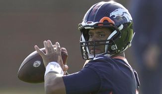Denver Broncos quarterback Russell Wilson throws the ball during a practice session in Harrow, England, Wednesday, Oct. 26, 2022 ahead the NFL game against Jacksonville Jaguars at the Wembley stadium on Sunday. (AP Photo/Kin Cheung)