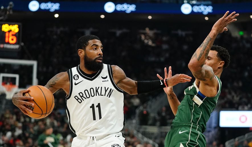 Brooklyn Nets&#39; Kyrie Irving tries to get past Milwaukee Bucks&#39; George Hill during the first half of an NBA basketball game Wednesday, Oct. 26, 2022, in Milwaukee. (AP Photo/Morry Gash)