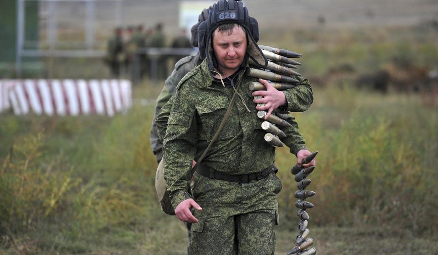Recruits carry ammunition during a military training at a firing range in the Rostov-on-Don region in southern Russia, Oct. 4, 2022. Since Russian President Vladimir Putin announced his mobilization on Sept. 21 for the war in Ukraine, independent media, human rights activists and draftees themselves have painted a bleak picture of a haphazard, chaotic and ethnically biased effort to round up as many men as possible and push them quickly to the front, regardless of skill or training. (AP Photo) **FILE**