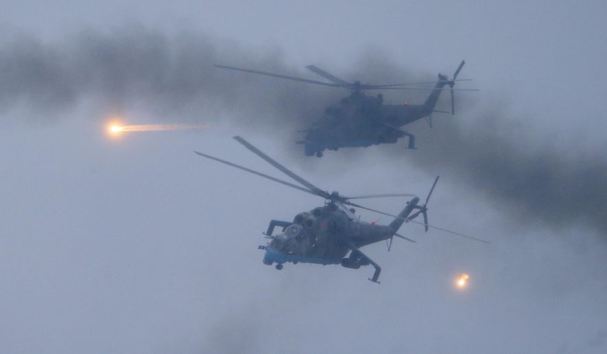FILE - Military helicopters fly over the Osipovichi training ground during the Union Courage-2022 Russia-Belarus military drills near Osipovichi , Belarus, Thursday, Feb. 17, 2022. (AP Photo/Alexander Zemlianichenko Jr., File)