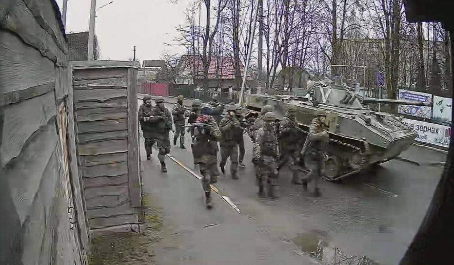 In this image from surveillance video, Russian troops take over Yablunska Street in Bucha, Ukraine on March 3, 2022, where they set up a headquarters during their month-long occupation. When Russian troops crossed from Belarus into Ukraine in late February, pressing toward Kyiv, they were ordered to block and destroy “nationalist resistance,” according to the Royal United Services Institute, a London think tank that has reviewed copies of Russia’s battle plans. (AP Photo)