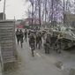 In this image from surveillance video, Russian troops take over Yablunska Street in Bucha, Ukraine on March 3, 2022, where they set up a headquarters during their month-long occupation. When Russian troops crossed from Belarus into Ukraine in late February, pressing toward Kyiv, they were ordered to block and destroy “nationalist resistance,” according to the Royal United Services Institute, a London think tank that has reviewed copies of Russia’s battle plans. (AP Photo)