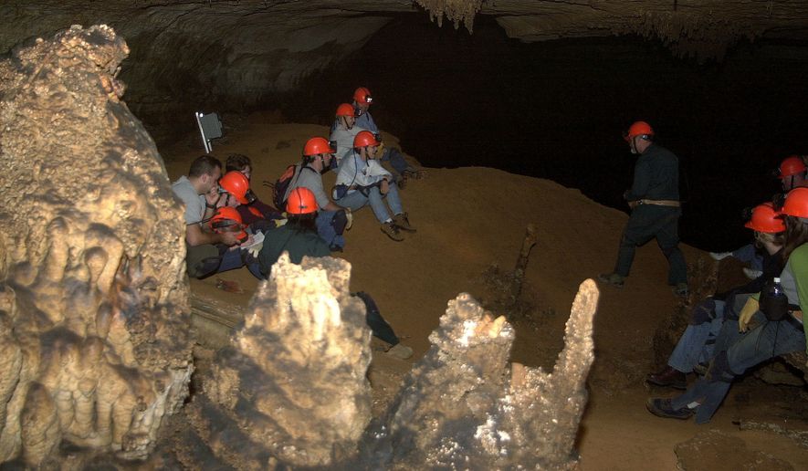 A group rests hundreds of feet underground at Blanchard Springs Cavern in the Ozark Mountains, Friday, Aug. 8, 2003, in Blanchard Springs, Ark. Small groups are outfitted with miner&#39;s helmets, head lamps, heavy-duty gloves and kneepads for the muddy excursions, paying between $20 and $80 for the four- to six-hour guided tour. (AP Photo/Mike Wintroath) **FILE**