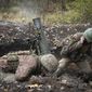 Ukrainian soldiers fire a mortar in the front line near Bakhmut, in the Donetsk region, Ukraine, Thursday, Oct. 27, 2022. (AP Photo/Efrem Lukatsky)