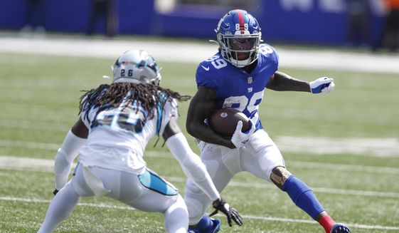 New York Giants&#39; Kadarius Toney, right, runs with the ball during the first half an NFL football game against the Carolina Panthers, on Sept. 18, 2022, in East Rutherford, N.J. The Kansas City Chiefs acquired Giants wide receiver Kadarius Toney on Thursday, Oct. 27, 2022, for a pair of picks in next year&#39;s draft, a person familiar with the terms of the trade told The Associated Press. (AP Photo/Noah K. Murray, File) **FILE**