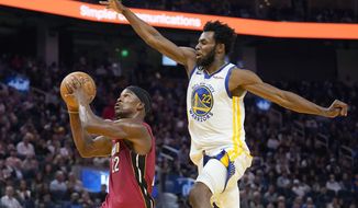 Miami Heat forward Jimmy Butler, left, shoots against Golden State Warriors forward Andrew Wiggins during the first half of an NBA basketball game in San Francisco, Thursday, Oct. 27, 2022. (AP Photo/Jeff Chiu)