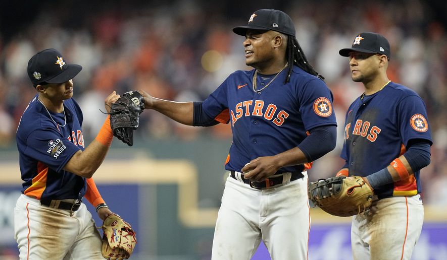 Houston Astros starting pitcher Framber Valdez, center, speaks with Jeremy Pena, left, on the mound during the seventh inning in Game 2 of baseball&#39;s World Series between the Houston Astros and the Philadelphia Phillies on Saturday, Oct. 29, 2022, in Houston. (AP Photo/Eric Gay)