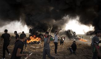 FILE - Palestinians burn tires during a protest against Israeli military raid in the West Bank, along the border fence with Israel, in east of Gaza City on Oct. 25, 2022. The U.N. Mideast envoy said 2022 is on course to be the deadliest year for Palestinians in the West Bank since the U.N. started tracking fatalities in 2005, and he called for immediate action to calm &amp;quot;an explosive situation&amp;quot; and move toward renewing Israeli-Palestinian negotiations. (AP Photo/Fatima Shbair, File)