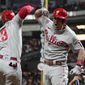 Philadelphia Phillies&#39; J.T. Realmuto, right, celebrates his solo homer with Philadelphia Phillies Bryce Harper during the 10th inning in Game 1 of baseball&#39;s World Series between the Houston Astros and the Philadelphia Phillies on Friday, Oct. 28, 2022, in Houston. (AP Photo/Eric Gay)