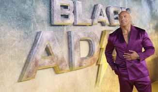 Dwayne Johnson poses for photographers upon arrival for the premiere of the film &#39;Black Adam&#39; on Tuesday, Oct. 18, 2022, in London. (Photo by Vianney Le Caer/Invision/AP)