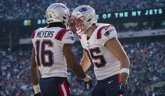 New England Patriots tight end Hunter Henry (85) celebrates with wide receiver Jakobi Meyers (16) after Meyers scored a touchdown against the New York Jets during the third quarter of an NFL football game, Sunday, Oct. 30, 2022, in New York. (AP Photo/John Minchillo)