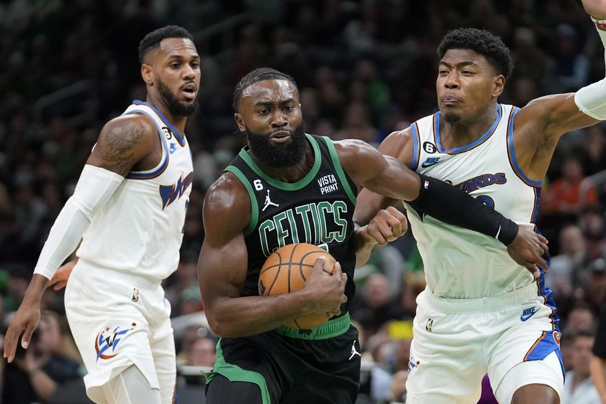Boston Celtics guard Jaylen Brown, center, vies for control of the ball with Washington Wizards guard Monte Morris, left, and forward Rui Hachimura in the first half of an NBA basketball game, Sunday, Oct. 30, 2022, in Boston. (AP Photo/Steven Senne) **FILE**