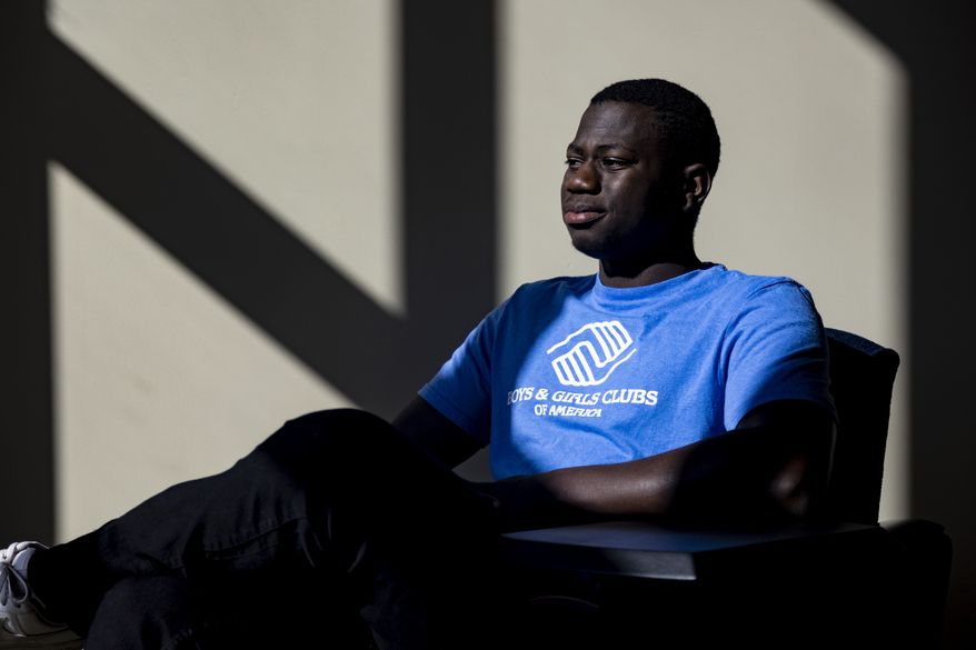 Steeve Biondolillo sits for a portrait on campus at Northwest Nazarene University in Nampa, Idaho on Friday, Oct. 7, 2022. With an early childhood in Haiti marked by poverty and other trauma, the 19-year-old seems to have beat long odds. Now a college sophomore majoring in social work, he envisions a career working with the needy. It has been a journey, he says, from "scared little kid to me, proud young man with big goals and a big future." (AP Photo/Kyle Green)