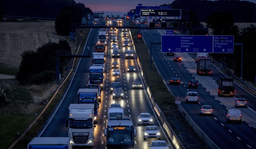Cars and trucks drive on a highway in Frankfurt, Germany, Wednesday, Aug. 31, 2022. Officials said Monday that Germany is postponing politically sensitive decisions on reducing greenhouse gas emissions in the transport sector until 2023, amid strong opposition from one governing party to the idea of a universal speed limit. (AP Photo/Michael Probst, file)