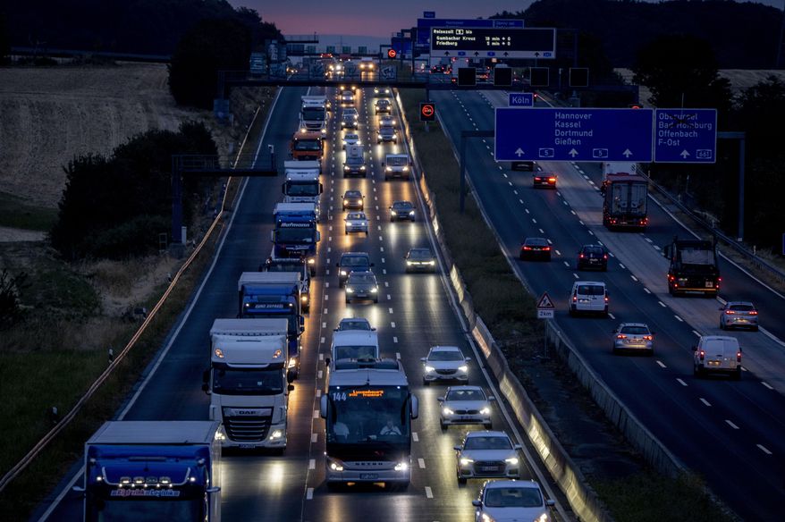 Cars and trucks drive on a highway in Frankfurt, Germany, Wednesday, Aug. 31, 2022. Officials said Monday that Germany is postponing politically sensitive decisions on reducing greenhouse gas emissions in the transport sector until 2023, amid strong opposition from one governing party to the idea of a universal speed limit. (AP Photo/Michael Probst, file)
