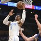 Los Angeles Lakers guard Russell Westbrook (0) goes to the basket against Denver Nuggets center Nikola Jokic (15) during the first half of an NBA basketball game Sunday, Oct. 30, 2022, in Los Angeles. (AP Photo/Michael Owen Baker)