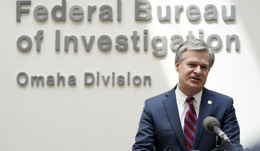FBI Director Christopher Wray speaks during a news conference on Aug. 10, 2022, in Omaha, Neb. The White House is bringing together three dozen nations, the European Union and a slew of private-sector companies for a two-day summit starting Monday, Oct. 31, 2022, that looks at how best to combat ransomware attacks. Several administration officials are planning to participate in the event, including Wray. President Joe Biden was not expected to attend. (AP Photo/Charlie Neibergall) **FILE**