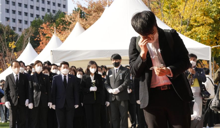 A mourner wipes his tear as he pays a silent tribute for victims of a deadly accident following Saturday night&#x27;s Halloween festivities, at a joint memorial altar for victims at Seoul Square in Seoul, South Korea, Monday, Oct. 31, 2022. (AP Photo/Ahn Young-joon)
