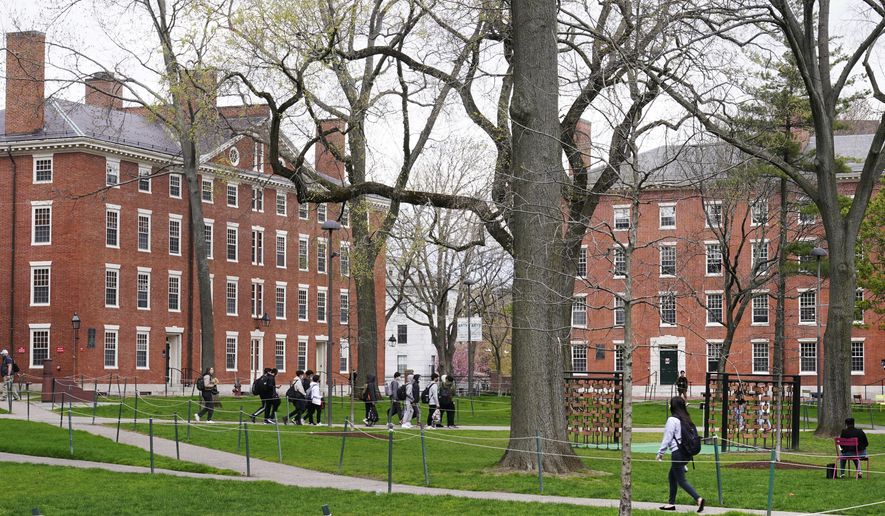 Students walk through Harvard Yard, April 27, 2022, on the campus of Harvard University in Cambridge, Mass. (AP Photo/Charles Krupa, File)
