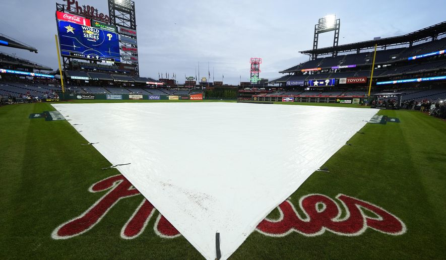 The field is covered with the threat of rain before Game 3 of baseball&#x27;s World Series between the Houston Astros and the Philadelphia Phillies on Monday, Oct. 31, 2022, in Philadelphia. (AP Photo/Matt Slocum)