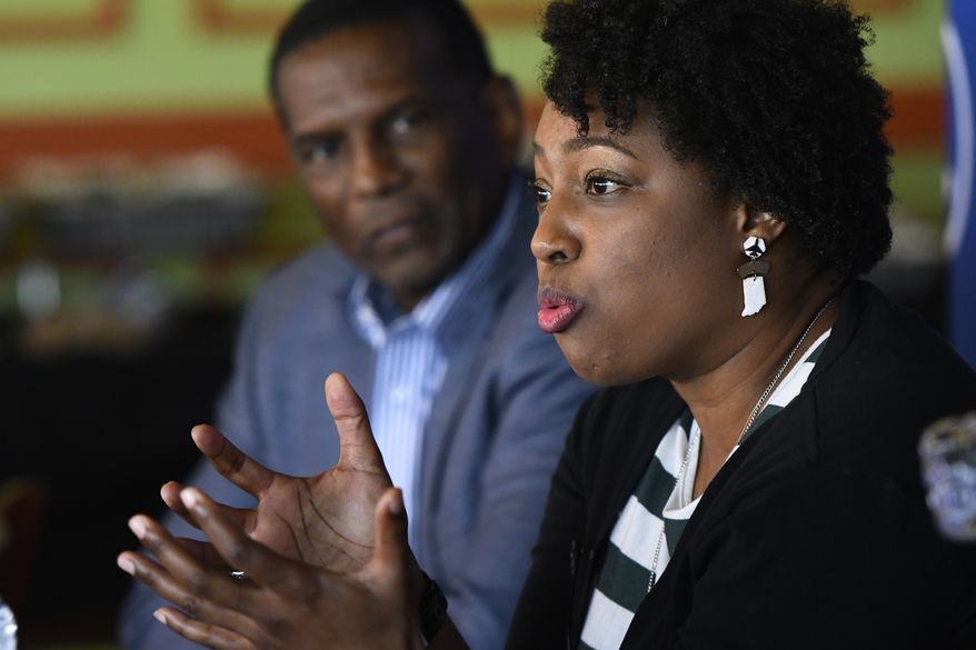 Jennifer-Ruth Green, the Republican candidate for Indiana&#x27;s 1st Congressional District and an U.S. Air Force veteran right, while Utah Rep Burgess Owens, left, listens during a roundtable meeting Thursday, Oct. 20, 2022, in Gary, Ind. (AP Photo/Paul Beaty)